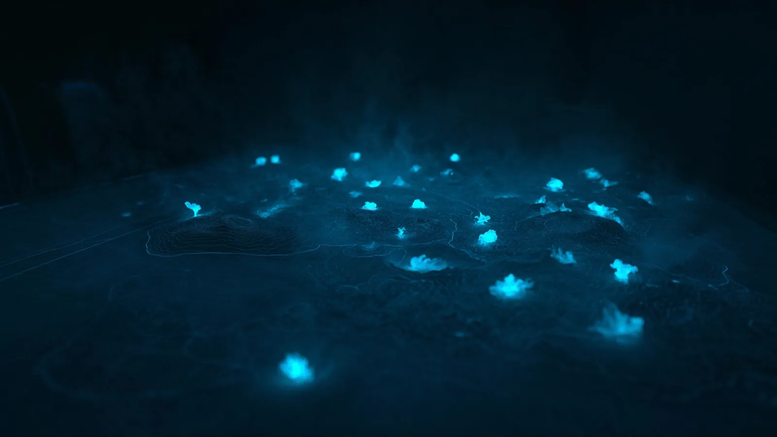 A war-room situation table rendering a coastline as a glowing cyan heatmap, with brighter intensity blooms scattered across the surface.